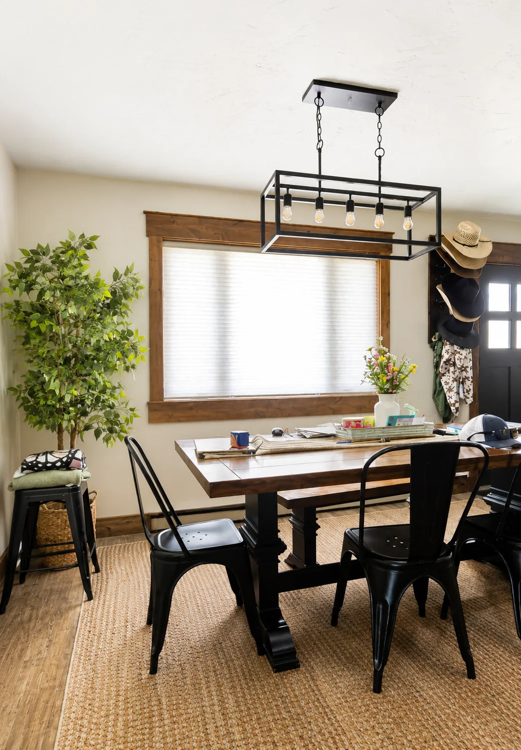White cellular shade filtering light in a warm dining room