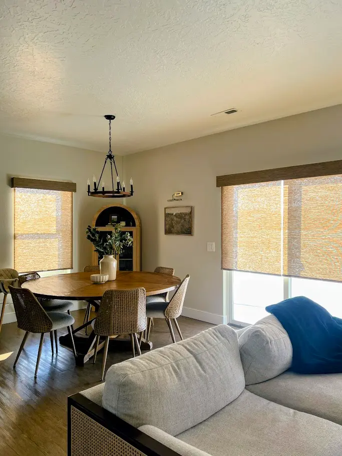 Woven shades in an open dining and living room